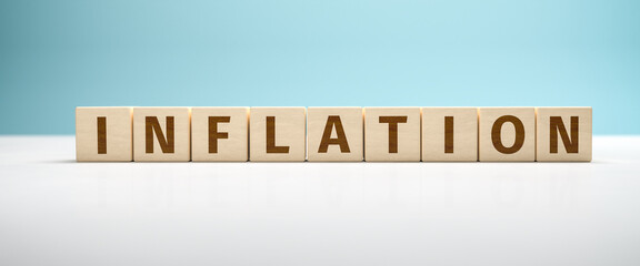 The word inflation built from toy blocks against a turquoise background. Web banner format