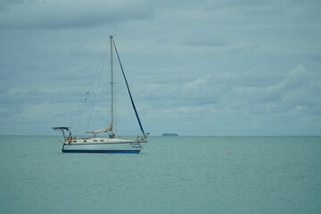 Fototapeta premium anchored sailboat mountains behind