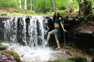 woman near mountain waterfall