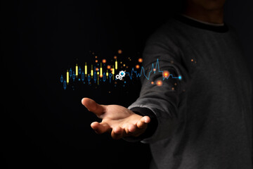  planning business and financial concept. Businessman holding virtual screen on growth graph chart and data