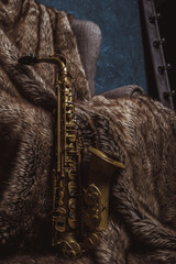 an old alto saxophone on a fur background