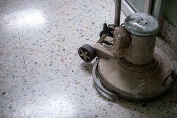 The floor scrubber looks old and dirty.