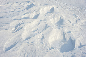 Coarse texture of the snow, accented by a sliding sun light