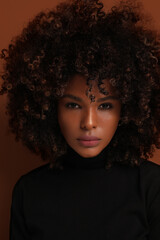 Vertical portrait of African American confident woman looking at the camera.