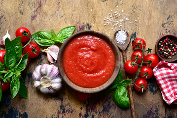 Homemade tomato sauce with ingredients for making. Top view with copy space.