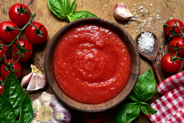 Homemade tomato sauce with ingredients for making. Top view with copy space.