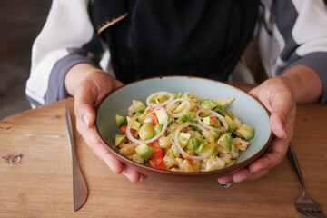 young women eating avocado salad 