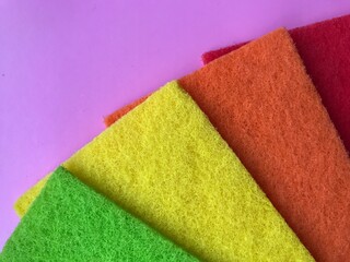 on a pink background colored washcloths for cleaning