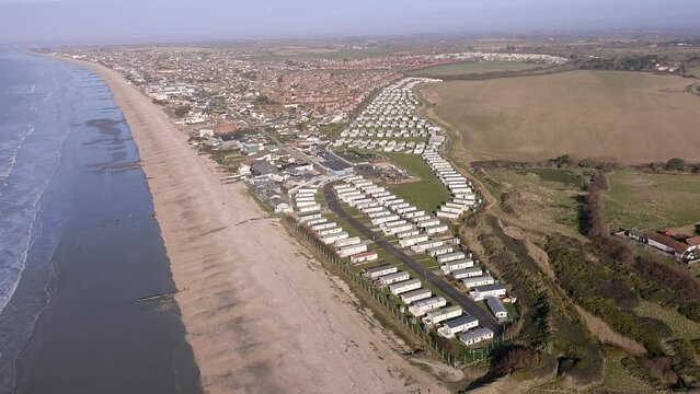 Aerial video along the south coast by Bracklesham Bay and the holiday resort caravan park near East Wittering.