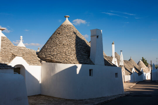 Trulli (traditional Dry Stone Huts With The Roof Made Of Dry-set Slabs) On Via Giuseppe Verdi, Aia Piccola, Alberobello, Puglia, Southern Italy