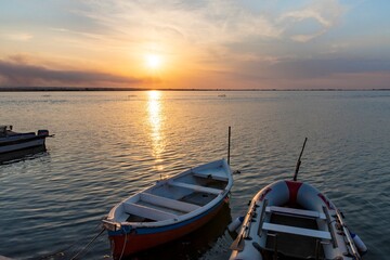 Beautiful background with boats in the lake at sunset