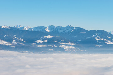 Fototapeta na wymiar Mist of fog over the swiss and austrian mountains