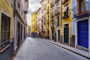 Narrow alley with colorful houses in the World Heritage city of Cuenca, Spain.