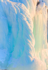 Ice and snow patterns and icicles on rocks in the cave - The rock on the frozen lake Baikal is covered with a thick layer - Baikal lake