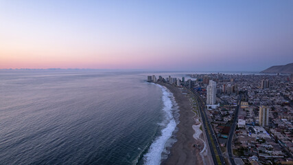 sunrise over the sea and the city of iquique