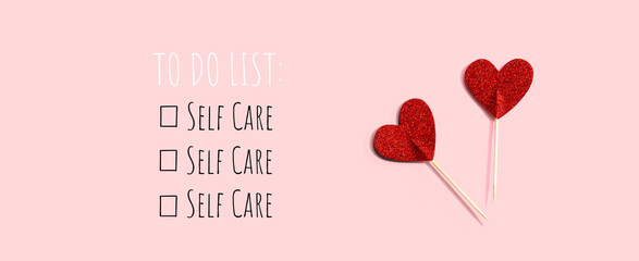 Self Care - To Do List with red glitter heart picks - flat lay