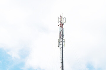 Obraz premium Telecommunication mast TV antennas in the afternoon ,on the hill blue sky with cloud bright at Phuket Thailand.