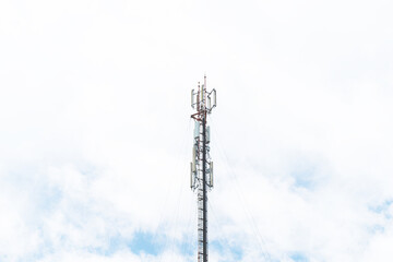 Obraz premium Telecommunication mast TV antennas in the afternoon ,on the hill blue sky with cloud bright at Phuket Thailand.