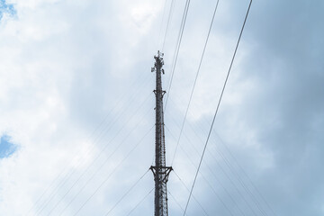 Obraz premium Telecommunication mast TV antennas in the afternoon ,on the hill blue sky with cloud bright at Phuket Thailand.