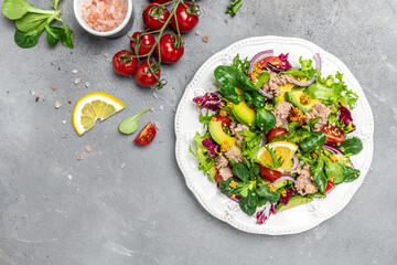 Tasty tuna salad with lettuce, cherry tomatoes, avocado and red onions. superfood concept. Healthy, clean eating concept. Vegan or gluten free diet. Top view