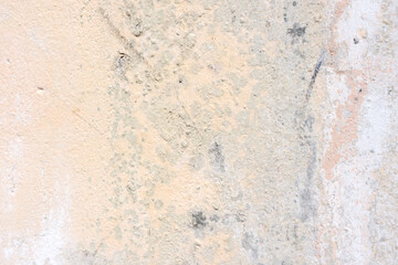 Grunge beige concrete background with peeling off paint