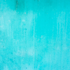 Textures of cyan painted grunge concrete background
