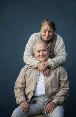 happy elderly married couple on blue background