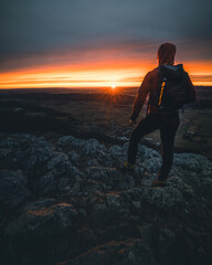 silhouette of a man in the sunset on a mountain top