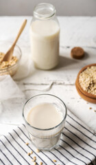Homemade barley milk in glass with ingredients