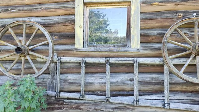 Old wooden shed wall with wheels and stairs. 