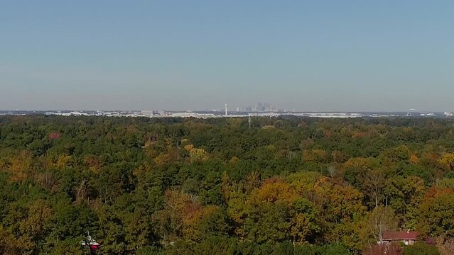 Aerial fall trees left to right side view of airport