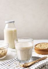 Homemade vegan barley milk in glass with seeds