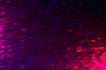 Defocused sparks. Neon glow background. Strokes flare pattern. Blur ultraviolet pink purple color light curved flecks on dark black overlay.