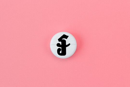 Medical pill with riel currency sign on a pink background. Rise in the price of medicines. Expensive medicine in Cambodia