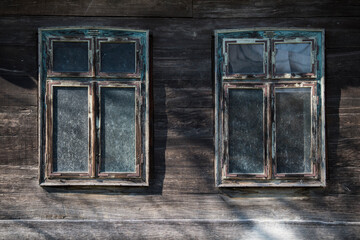 Sunja, Croatia, 05,04,2021: Rustic style aged window in wooden village rural home wall.