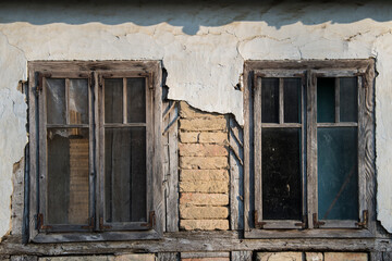 Sunja, Croatia, 05,04,2021: Rustic style aged window in wooden village rural home wall.