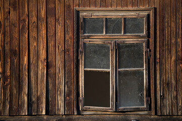 Obraz na płótnie Canvas Sunja, Croatia, 05,04,2021: Rustic style aged window in wooden village rural home wall.