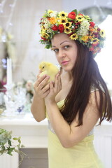 Beautiful girl in a yellow dress holding a duck