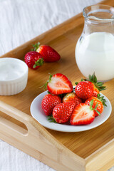 Strawberries and milk on a tray