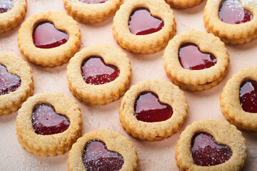 Traditional Linzer cookie with strawberry jam and powder sugar on pink beautiful background. Top view. Traditional homemade Austrian sweet dessert food on Valentines Day. Holiday snack concept.