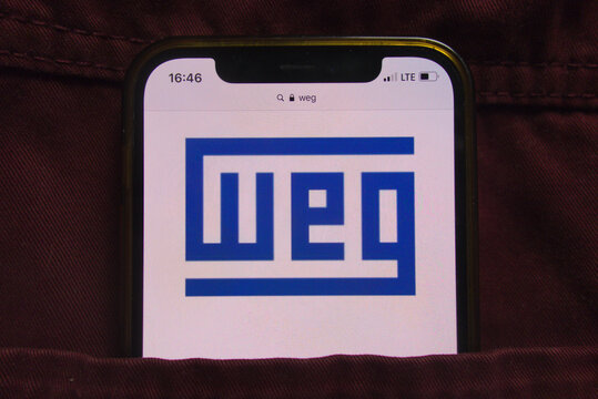 KONSKIE, POLAND - February 22, 2022: WEG SA company logo on mobile phone hidden in jeans pocket