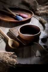 Wooden utensils on a rustic table in contrasting lighting