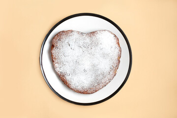 heart shaped cake cooking at home. powdered sugar pie ready to serve on white plate on beige background. Step by step photo instruction. Step 4