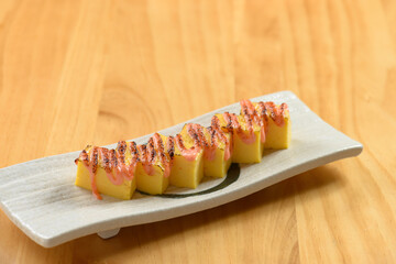 japanese food Tamagoyaki in a white dish isolated on wooden table top view