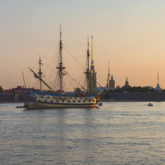 Russian old military sailboat stands on the Neva River near the Peter and Paul Fortress in the center of St. Petersburg