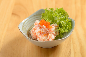 japanese food Shishamo Mentai sauce in a bowl isolated on wooden background top view