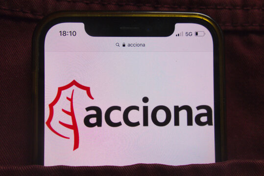 KONSKIE, POLAND - February 22, 2022: Acciona SA company logo on mobile phone hidden in jeans pocket