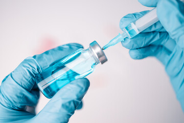 Fototapeta premium Doctor or scientist holding syringe with syringe with booster dose liquid vaccines. Vaccination and immunization.