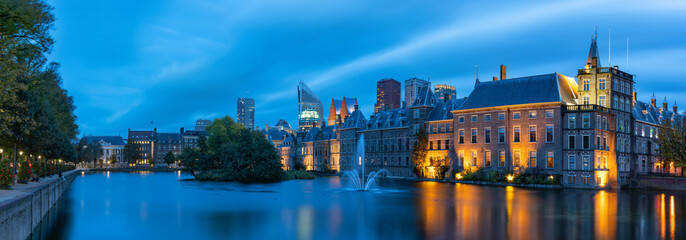 Panoramic photo during the blue hour on a windy autumn day of the Hofvijver and the Binnenhof with...