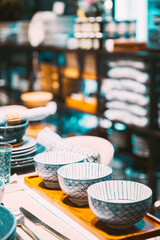 View of assortment of decor for interior shop in store of shopping center. Home accessories and household products for dining room in store of shopping centre. View of dinnerware on table. Home